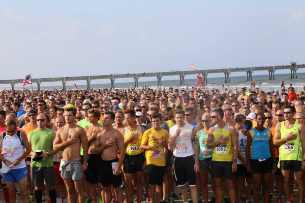 People lined up for a race at the beach