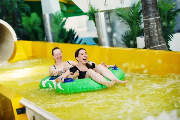 people enjoying a water slide at a water park